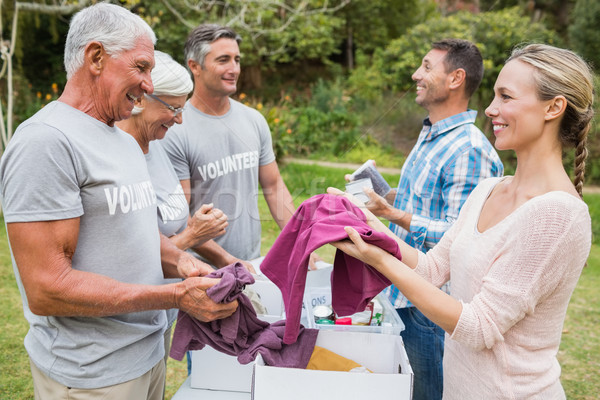 5859646_stock-photo-happy-volunteer-family-separating-donations-stuffs