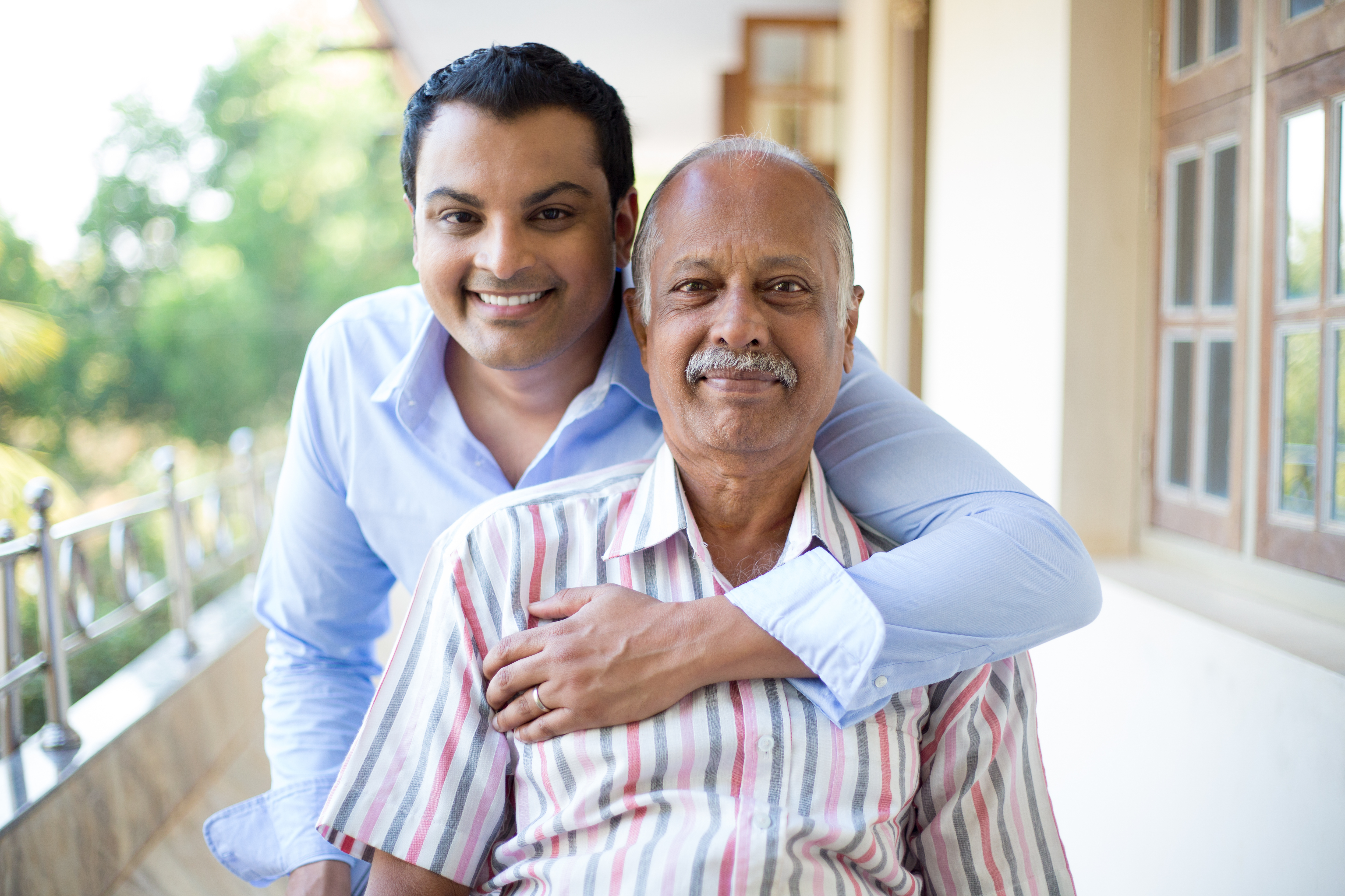 Father and son sitting on an outdoor patio