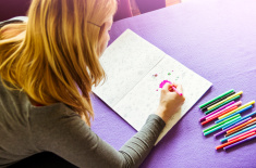 stock-photo-87569387-young-woman-drawing-adult-coloring-book-at-home
